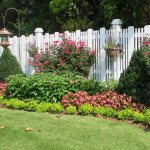 long flower bed along the fence