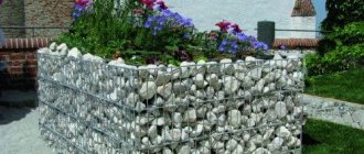 Flower bed made of stones in a steel mesh