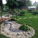 beautiful area with a bridge and a dry stream